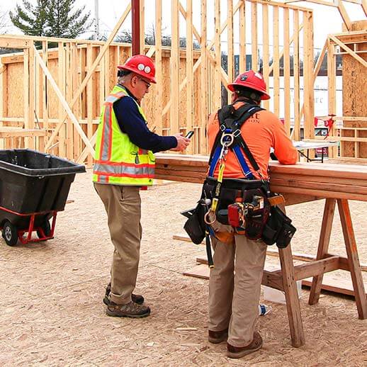 Project Manager and Laborer working together on West Michigan construction site