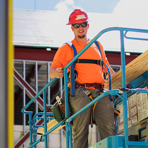 West Michigan Construction Worker on job site in high lift